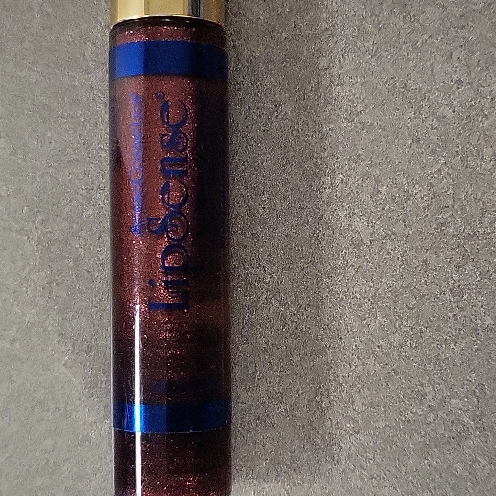 Senegence moisturizing lip gloss, red glitter in color, new in pkg